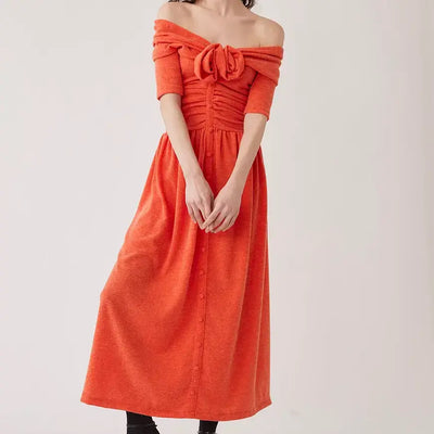 Model is posed in the orange Adelena Knit Dress from Tach available at Saint Claude Social Club. 