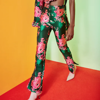 Model posed in green, rose-printed Falu Pant from Celia B. 