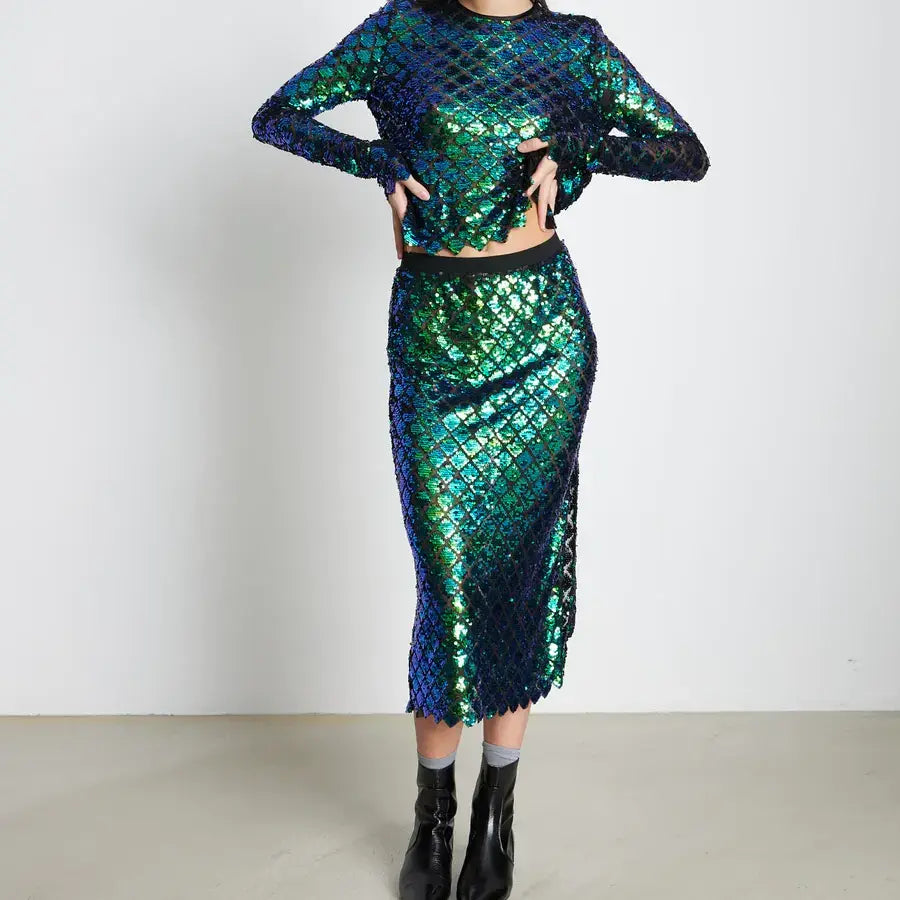 Model posed in the Aqua Sequin Skirt and Aqua Sequin Blouse from Stella Nova.